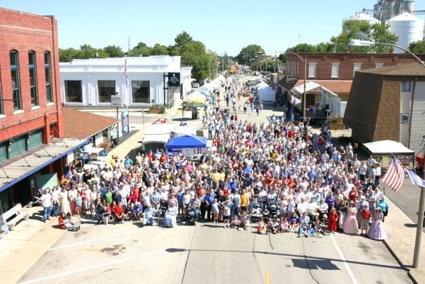 Crowd of people, aerial, in Maroa, IL town center
