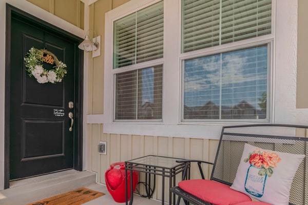 Porch with front door and seating area